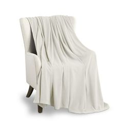 a white chair with a blanket on it