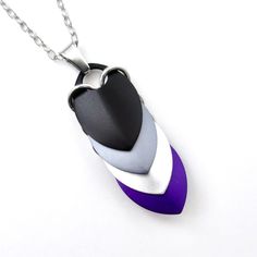 the necklace is shaped like a heart and has purple, white, and black colors