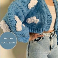 a woman wearing a blue knitted jacket with clouds on it and the text, digital pattern