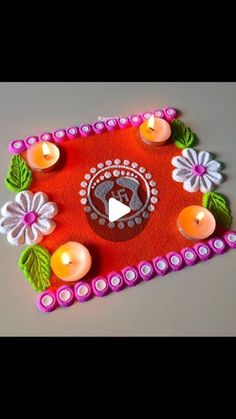 a decorated tray with candles and flowers on it for diwaling or decorating