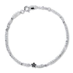 This darling bracelet, perfect for young teens, features a star accented with a black diamond and a trail of white diamonds. Styled in sterling silver, the bracelet adjusts from 7 to 7.5 inches in length and secures with a spring ring clasp. Black diamonds are treated to permanently create the intense black color. Fancy Diamonds, Black Bracelets, Star Bracelet, Bracelet Black, White Diamonds, Diamond Stone, Bracelet Designs, Spring Rings, Black Diamond