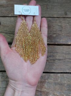 Gold Dangle Earrings With Beaded Chain, Gold Beaded Chain Drop Earrings, Gold Beaded Drop Earrings With Beaded Chain, Gold Beaded Chain Earrings As Gift, Bohemian Gold Earrings With Beaded Chain, Gold Beaded Earrings With Ear Wire For Party, Handmade Gold Beaded Drop Earrings, Elegant Gold Tassel Earrings With Round Beads, Gold Tassel Earrings With Round Beads