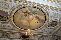 an ornate ceiling with paintings and chandelier