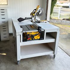 a workbench with tools on it sitting in the garage next to a window