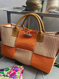 an orange purse sitting on top of a table