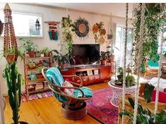 a living room filled with lots of plants and furniture