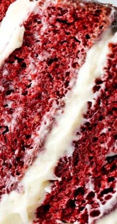 a slice of red velvet cake with white frosting