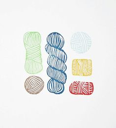 three balls of yarn are next to each other on a white surface with multicolored stripes