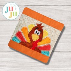 a turkey applique on an orange coaster