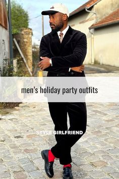 stylish man wearing a brown corduroy double-breasted suit with a plaid tie, red socks, and dark loafers. text on-screen reads: men's holiday party outfits (style girlfriend)