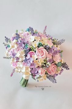 a bridal bouquet with purple and white flowers