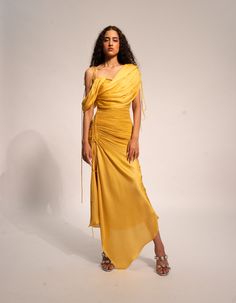 Rosie dress with detachable right sleeve and shoulder tie-upThe stunning Yellow Ray Draped Body Fit Dress, is crafted in luxurious breathable modal satin with ruched details, an adjustable slit, and detachable drape sleeves. This elegant dress flatters your figure, while the adjustable slit allows you to reveal just th Satin Drape Dress, Panelled Dress, Pleated Drapes, Drape Sleeves, Dyed Dress, Draped Dress, Dress For Women, Women Dresses, Elegant Dress