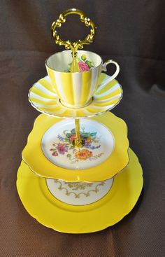 three plates stacked on top of each other with cups and saucers in the middle