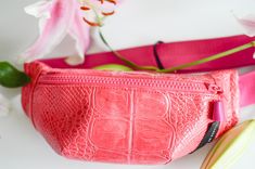 "ABOUT:  Pink embossed small fanny pack with black zipper and a small pouch pocket inside for storage. Adjustable pink strap with black buckle. Great for everyday style and vacations.  -------------------------------------------------------------------------------------------------------- DESCRIPTION:  - front zipper closure - pocket on back of pack - lined interior - inside pocket  - handmade Dimensions are approximately as follows: - 10.5\" Long x 4\" Tall x 2\" Width - straps are about 42\" long for crossbody wear (can be adjusted smaller) Color - pink bag - pink zipper - black buckle - pink straps *Actual colour may vary from picture due to computer settings. -------------------------------------------------------------------------------------------------------- MAIN FABRIC 100% PVC  L Pink Pouch Belt Bag, Trendy Pink Belt Bag With Zipper Pocket, Pink Crossbody Belt Bag With Zipper, Casual Pink Belt Bag With Zipper Closure, Pink Pouch Belt Bag For Travel, Pink Crossbody Belt Bag For Travel, Everyday Pink Pouch Belt Bag, Pink Belt Bag With Zipper For Everyday, Pink Belt Bag With Adjustable Strap For Travel