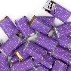 a pile of purple wrapped chocolate bars sitting on top of each other