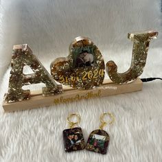 two pieces of jewelry sitting on top of a white furnishing covered floor next to each other