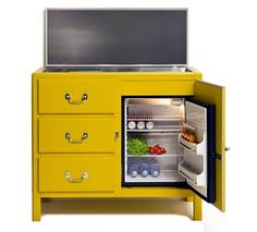 an open yellow refrigerator with its door open and food in the freezer inside it