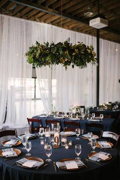 an image of a table set up with place settings and wine glasses on the table