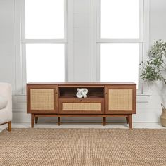 a living room scene with focus on the entertainment center and chair in the foreground