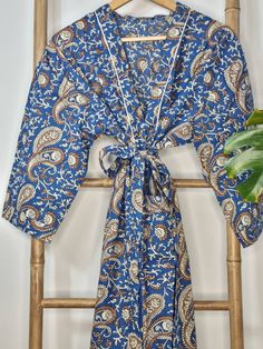 "Pls choose Express Upgrade for International Pre-Christmas Deliveries specially USA/Canada when purchasing 1 item specially. We cannot guarantee delivery on Standard Shipping. Primarily Unisex ! Perfect for lounging. Hand-block prints robes which are printed in Gujarat/Rajasthan (western India) and then beautifully made by our wonderful team in a small batch based in Jaipur. Size: Free Size , Fits Shirt Size : upto UK 48 shirt size comfortably . Stitched Chest Size : 50 \" Fabric : 100% Cotton Blue Cotton Holiday Sleepwear, Blue Bohemian Sleepwear With Floral Print, Blue Bohemian Floral Print Sleepwear, Bohemian Blue Floral Print Sleepwear, Blue Bohemian Sleepwear For Home, Funky House, Summer Kimono, Printed Robe, Boho Kimono