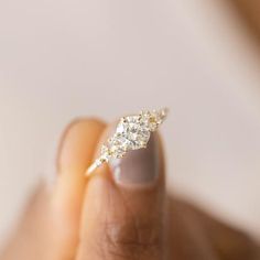 a woman's hand with a diamond ring on it