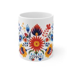 a white mug with colorful flowers on it