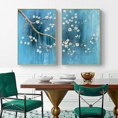 two paintings hanging on the wall above a dining room table with chairs and place settings