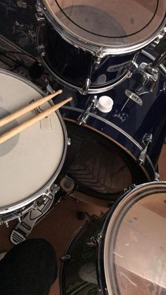 drums and sticks are laying on the floor