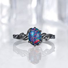 an opal ring with leaves on it