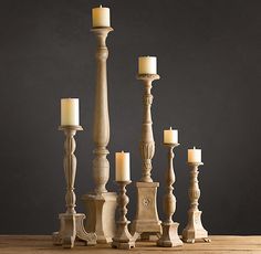 a group of candles sitting on top of a wooden table