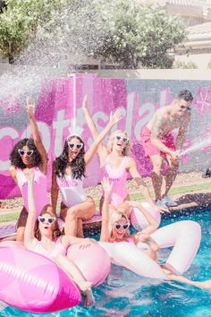 the girls are having fun in the pool with their pink rafts and floaties