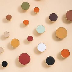 several different colored discs on a beige surface