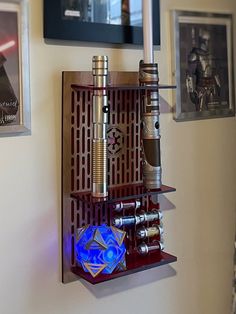 a star wars themed shelf with some items on it and framed pictures above the shelves