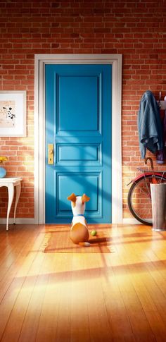 a dog sitting on the floor in front of a blue door