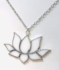 a necklace with a white flower on it