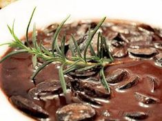 mushroom gravy with fresh rosemary garnish on top