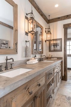 a bathroom with double sinks and wooden cabinets