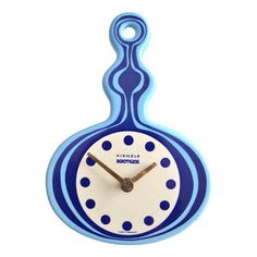 a blue and white clock sitting on top of a table