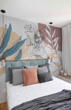 a large bed sitting in a bedroom next to a wall with flowers painted on it