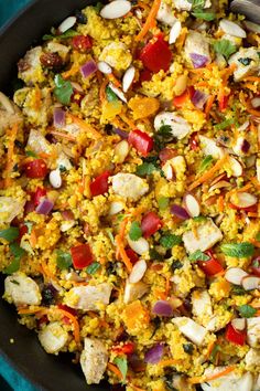 a pan filled with rice and vegetables on top of a table