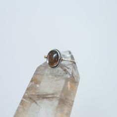 Sometimes you want to gaze down at your ring and see perfect balance and grace. That's what this Dainty Smoky Quartz Delica Ring has to offer. High-grade smoky quartz stone with a simple, sterling silver design. Perfect little ring. Lovely, traditional, dainty ring of 10X12 mm Smoky quartz cabochon set in .925 sterling silver oxidized and burnished bezel and wire. Simple, elegant and perfect. This lovely, translucent, and sparkling warm, taupe grey-colored ring is created using traditional silve Oval Sterling Silver Rings With Si Clarity, Oval Sterling Silver Ring With Si Clarity, Spiritual Sterling Silver Round Birthstone Ring, Sterling Silver Ring With Si Clarity, Spiritual Sterling Silver Stackable Rings, Round Sterling Silver Ring With Si Clarity, Spiritual Sterling Silver Toe Ring, Spiritual Open Ring Moonstone In Sterling Silver, Adjustable Oval Spiritual Rings