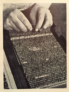 an old photo of a person's hands over a typewriter screen with letters on it