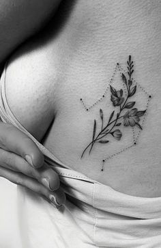 a woman's stomach with flowers and stars on her chest, in black and white