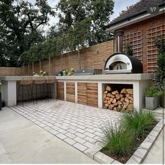 an outdoor kitchen with wood stacked in it