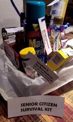 a bunch of items sitting on top of a table next to a sign that says senior citizen survival kit