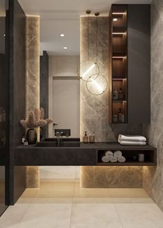 a modern bathroom with marble walls and flooring, lighted by pendant lights above the sink