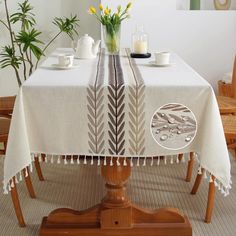 a table with a white table cloth and some yellow flowers on top of the table