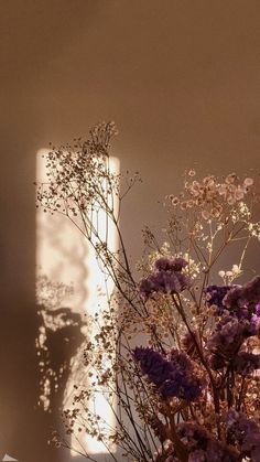 a vase filled with lots of purple flowers