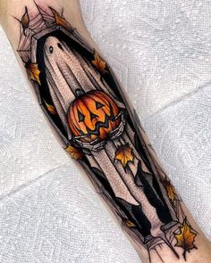 a halloween themed tattoo on the arm