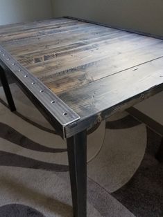 a wooden table sitting on top of a carpeted floor